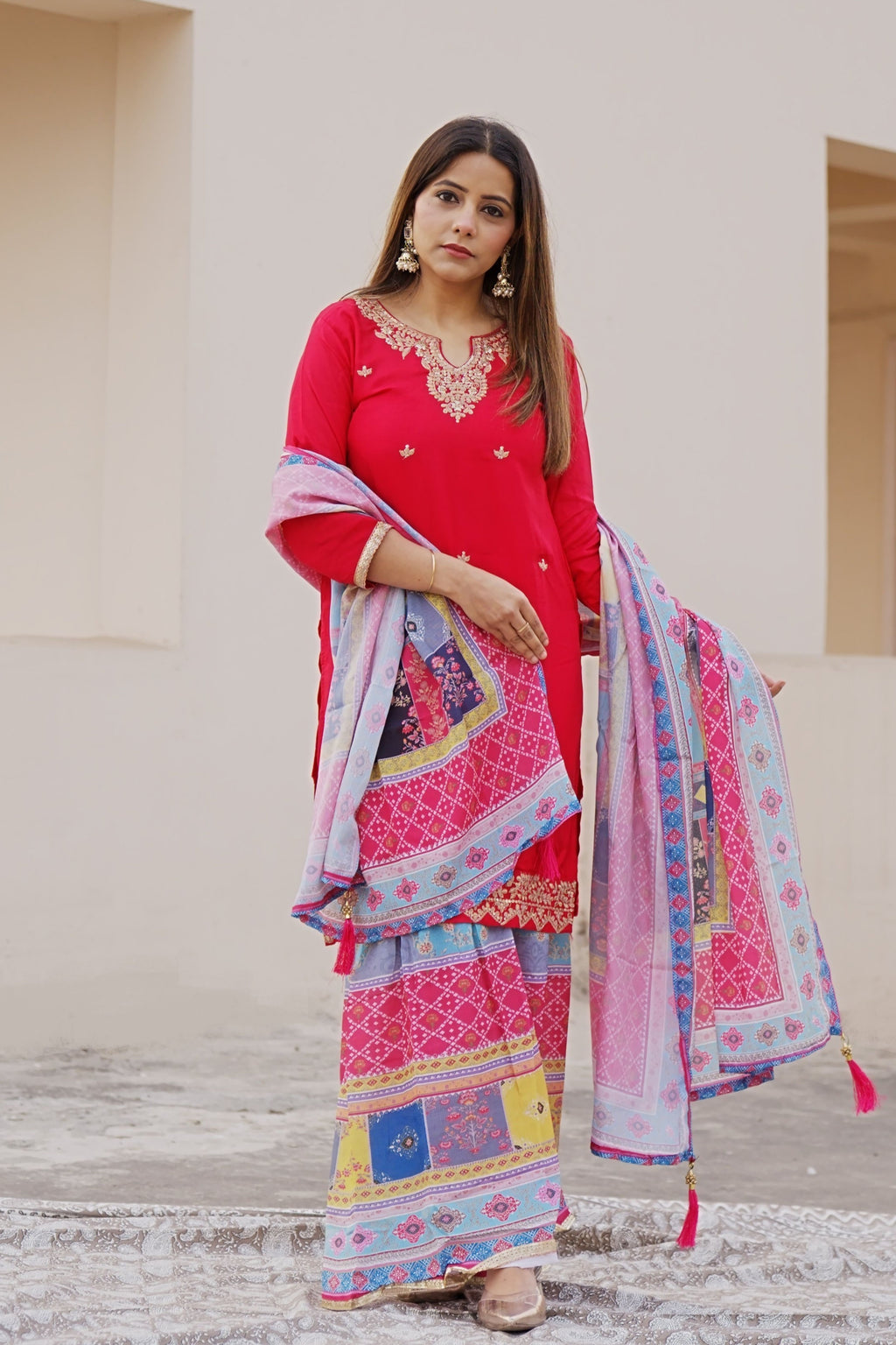 Shuchi Man Rani Pink kurta set with floral sharara pants and matching dupatta, featuring intricate embroidery and vibrant design.