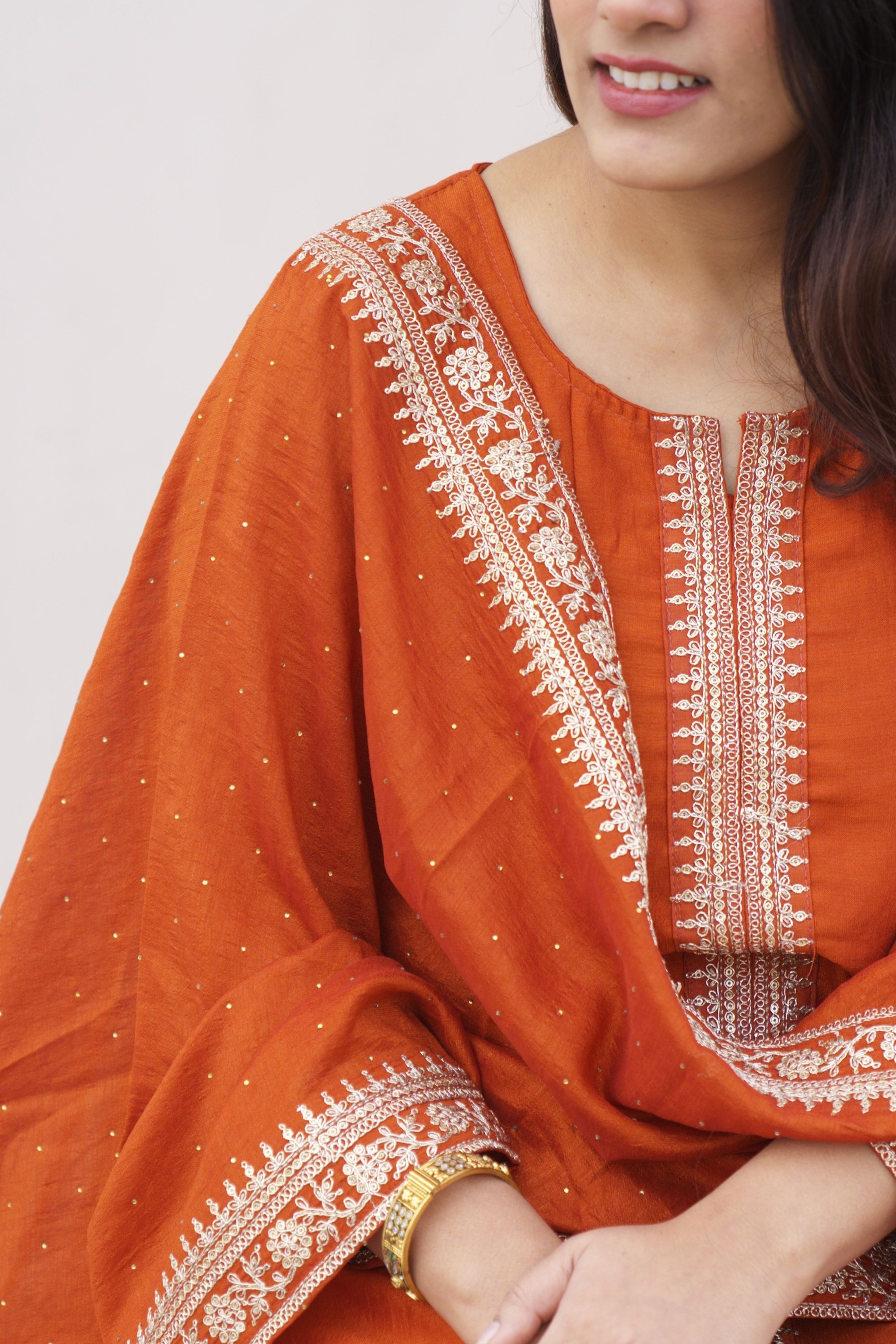 Rust Radiance Silk Anarkali Set by Shuchi Man featuring intricate embroidery and flowing fabric, ideal for festive occasions.