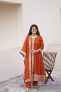 Rust Radiance Silk Anarkali set by Shuchi Man featuring a flowing silk Anarkali with intricate embroidery and matching dupatta.