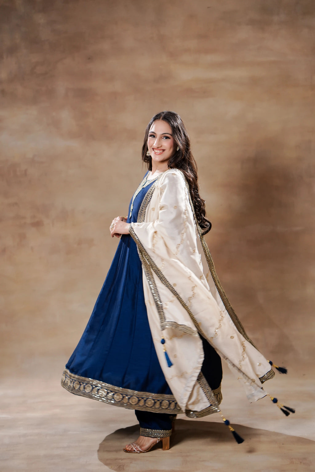 Midnight blue silk Anarkali with ivory dupatta, intricate embroidery, and flowing fabric, by Shuchi Man.