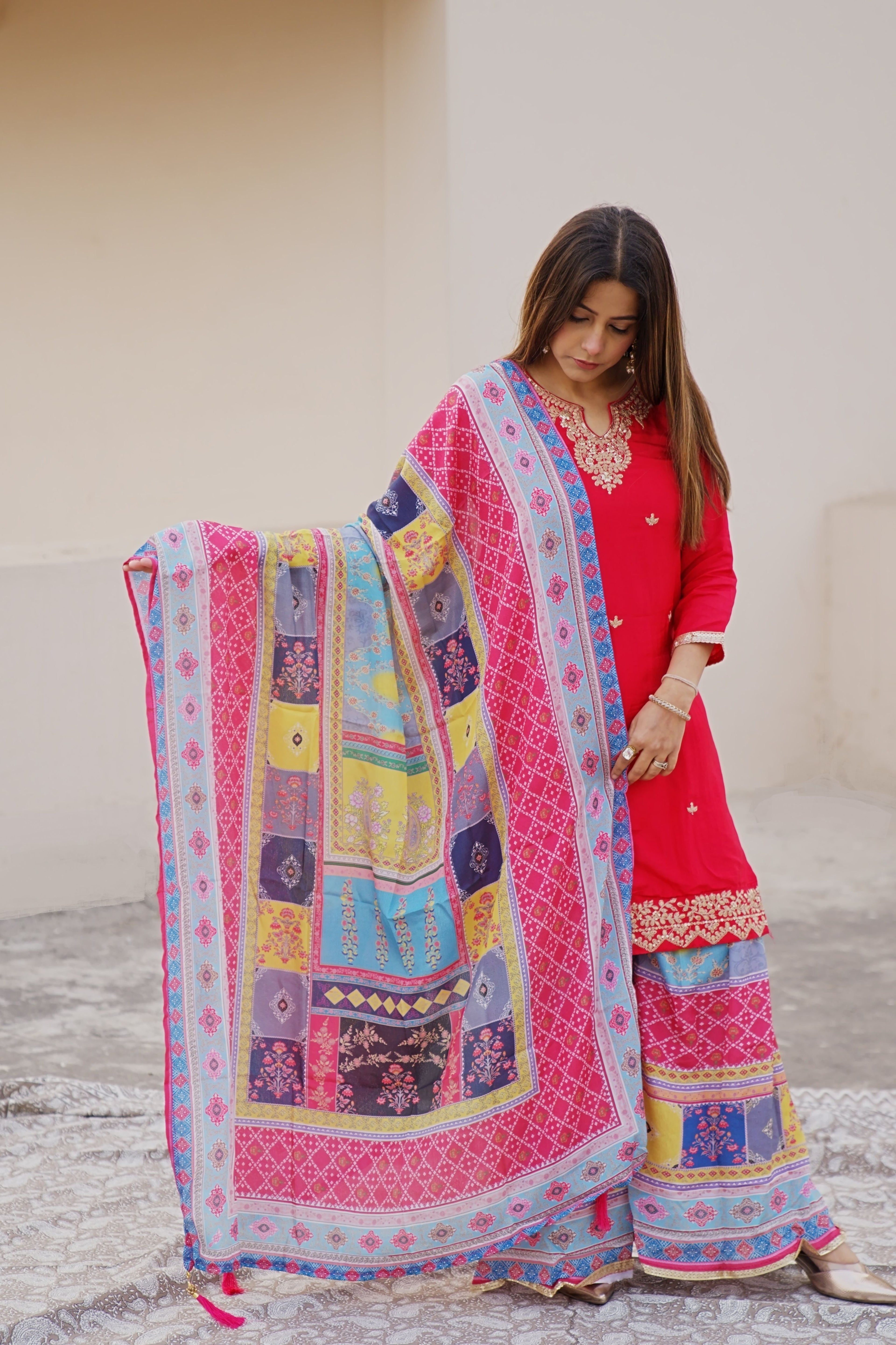 Shuchi Man pink kurta set with floral sharara and matching dupatta, featuring intricate embroidery and traditional design.