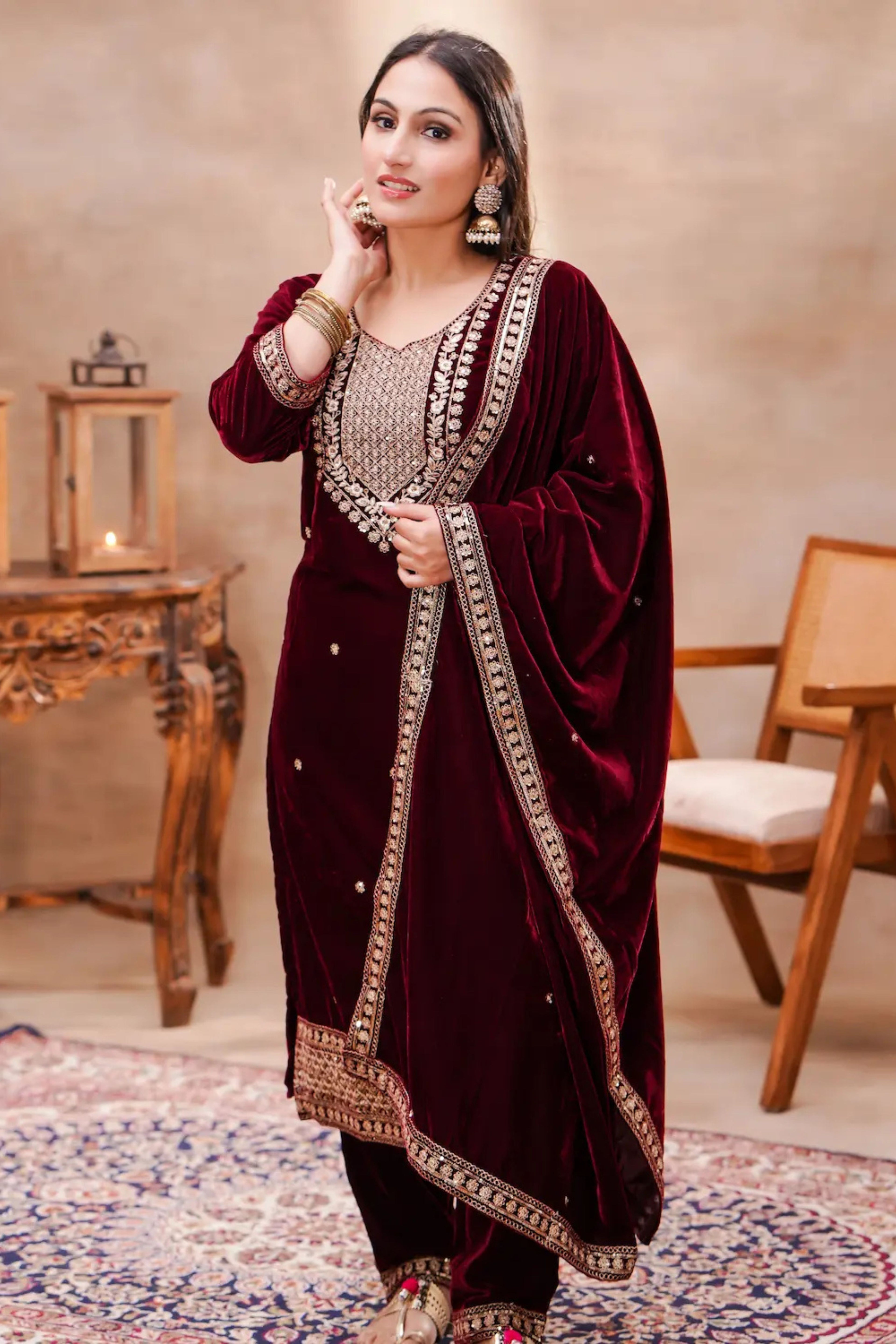 Royal maroon velvet embroidered suit set by Shuchi Man, featuring intricate embroidery and elegant fabric details.