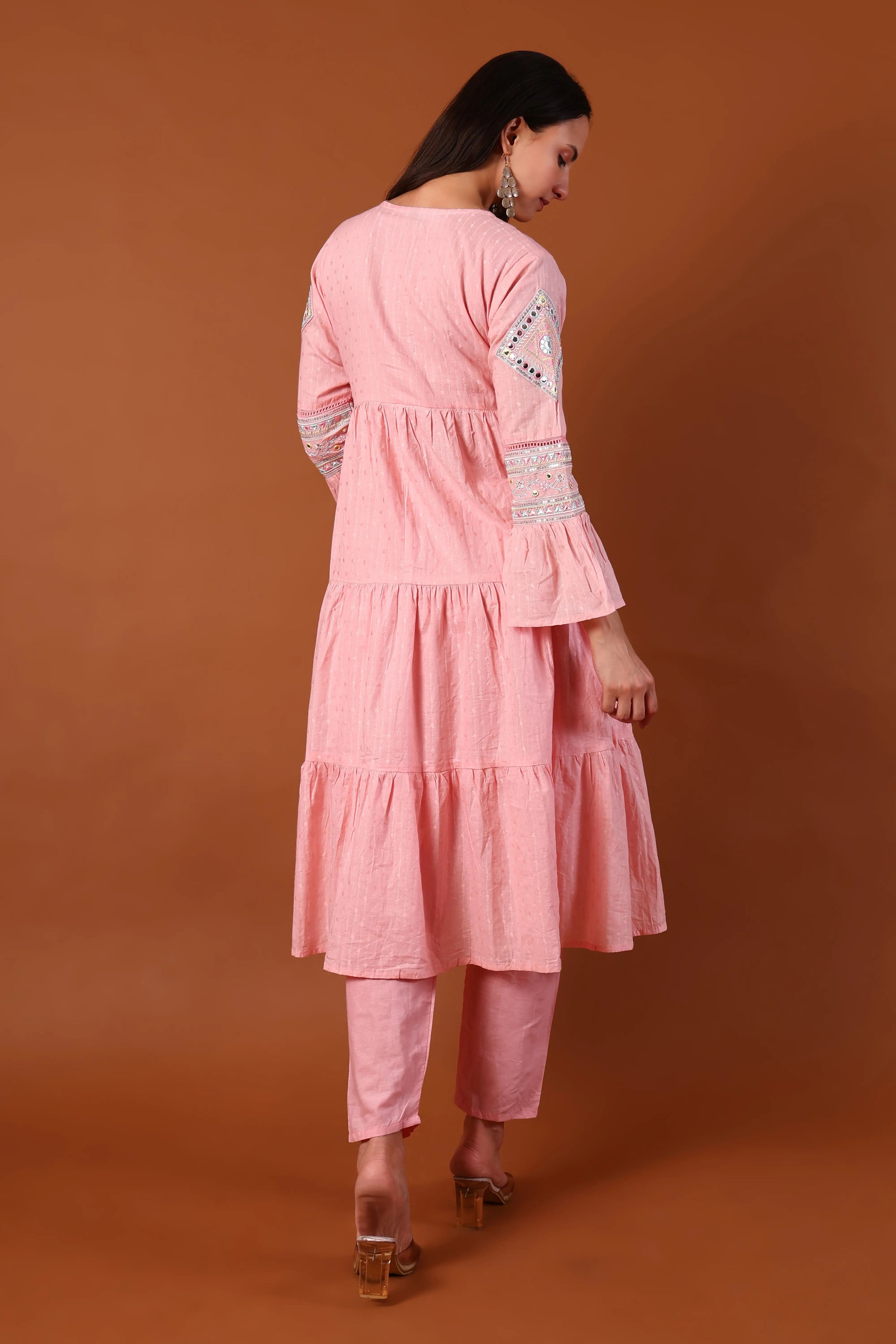 Blush cotton kurta set with kauri embellishments from Shuchi Man, featuring intricate embroidery and traditional design.