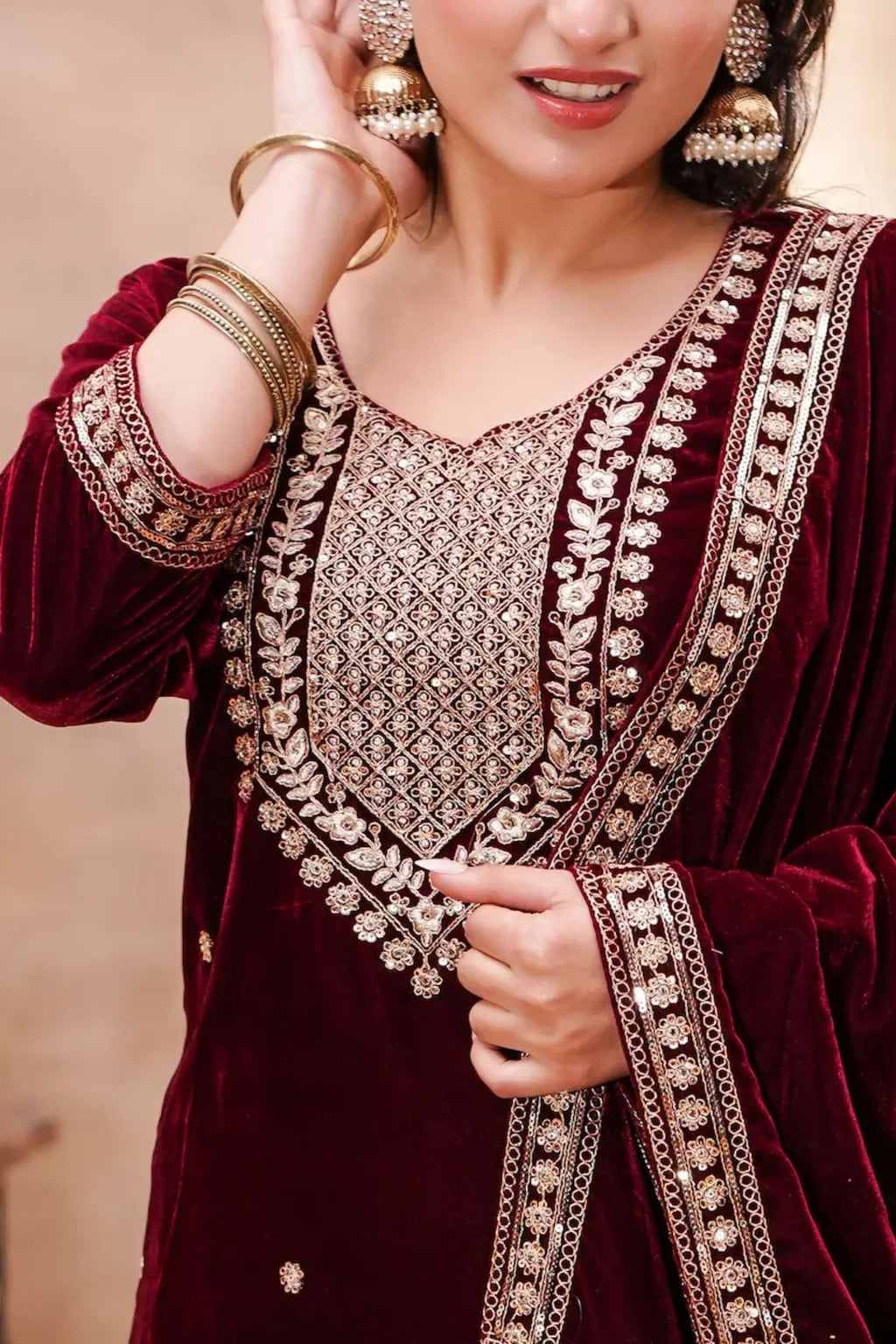 Royal maroon velvet embroidered suit set by Shuchi Man, featuring intricate embroidery and elegant fabric details.