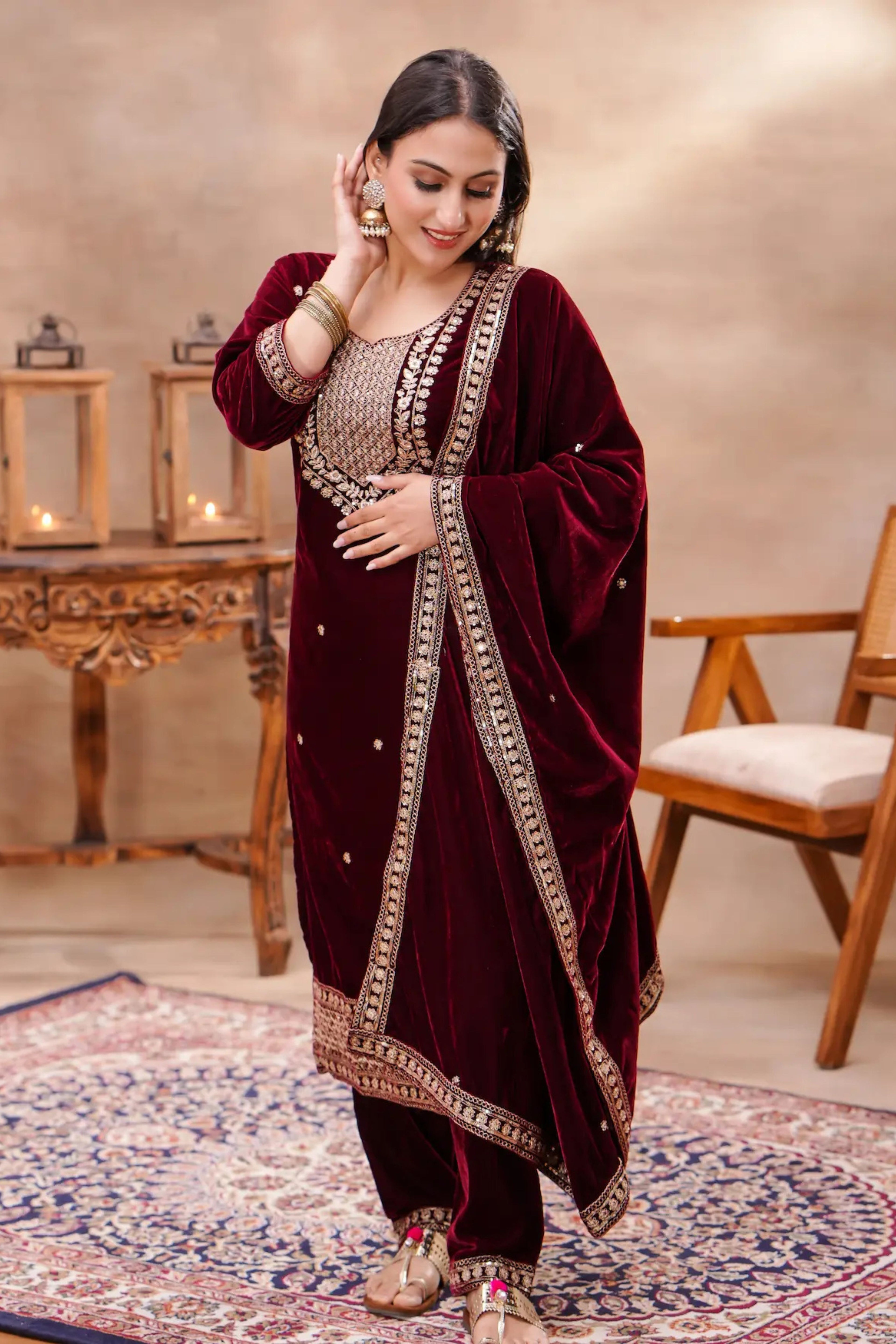 Royal maroon velvet embroidered suit set by Shuchi Man, featuring intricate embroidery and elegant fabric.