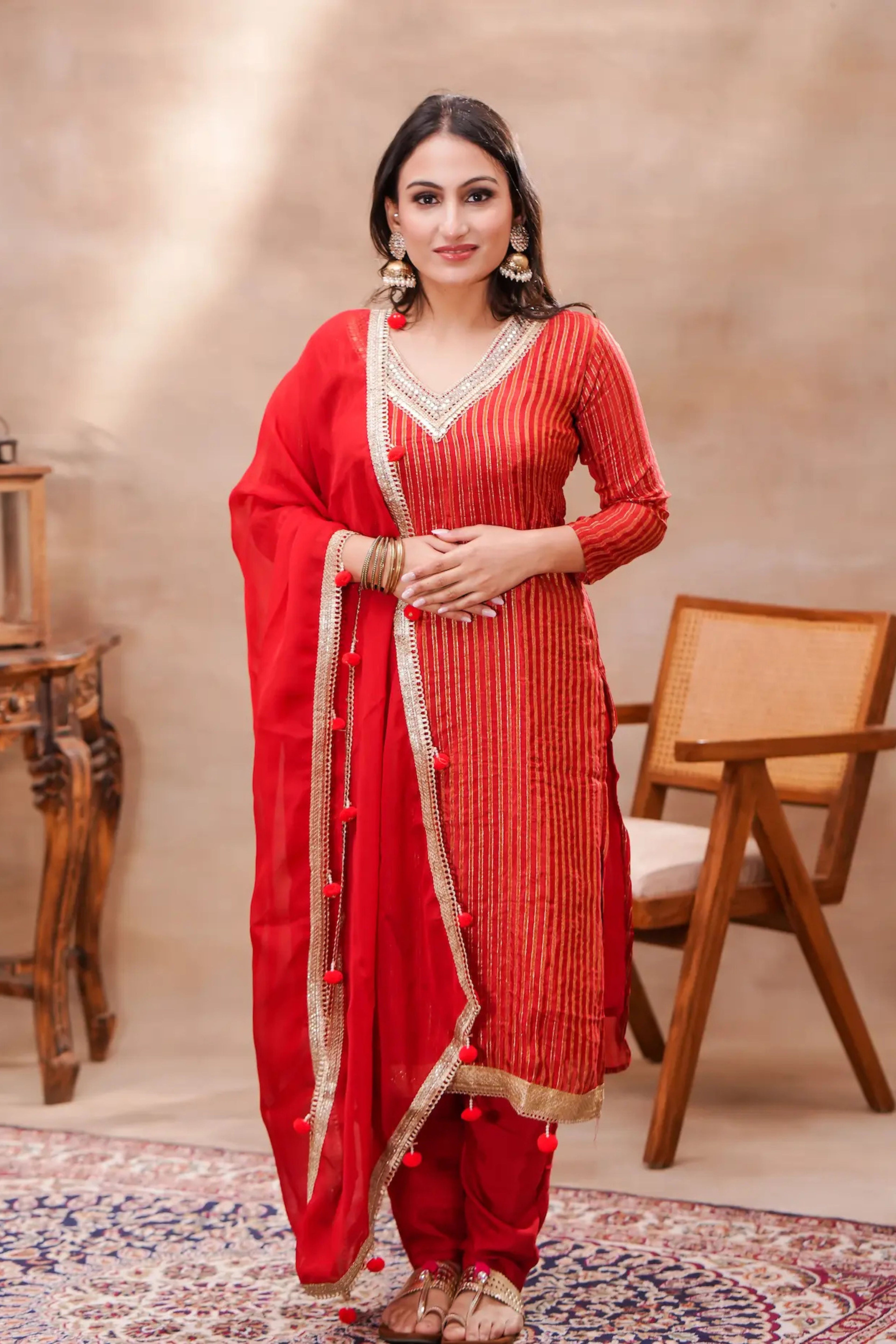 Crimson silk kurta set with matching dupatta by Shuchi Man, featuring intricate embroidery and elegant traditional design.