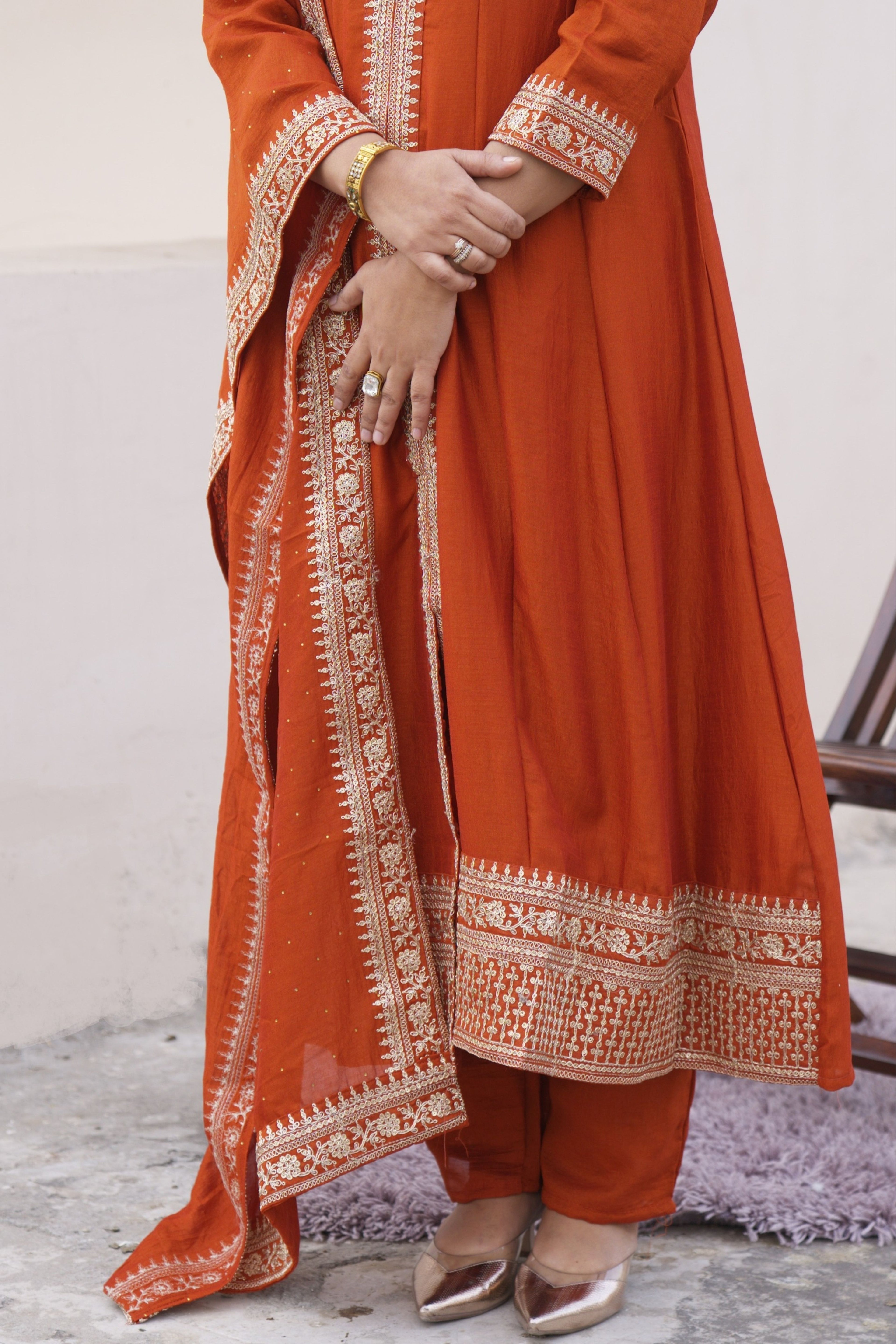 Rust Radiance Silk Anarkali Set by Shuchi Man featuring intricate embroidery and flowing silk fabric.