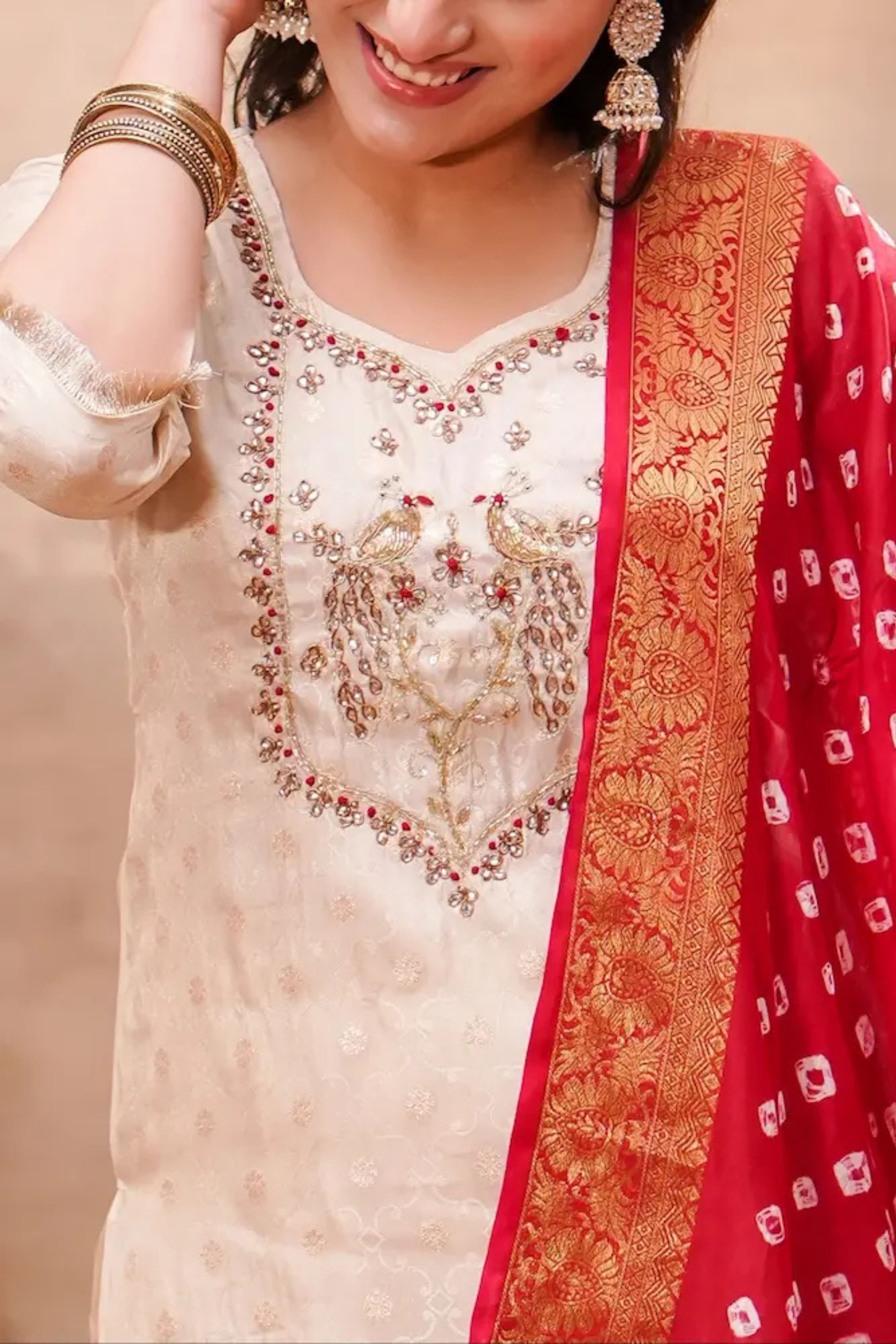 Ivory silk kurta set with intricate bandhani dupatta by Shuchi Man, featuring traditional design and elegant fabric details.