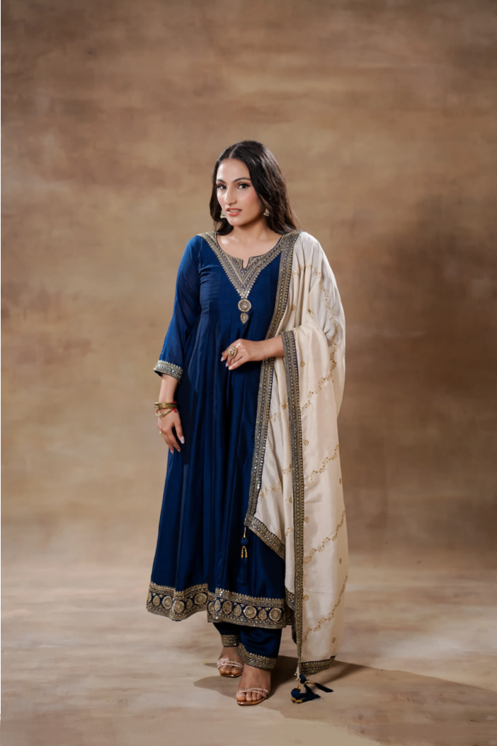 Midnight blue silk Anarkali dress with intricate design paired with an elegant ivory dupatta, by Shuchi Man.