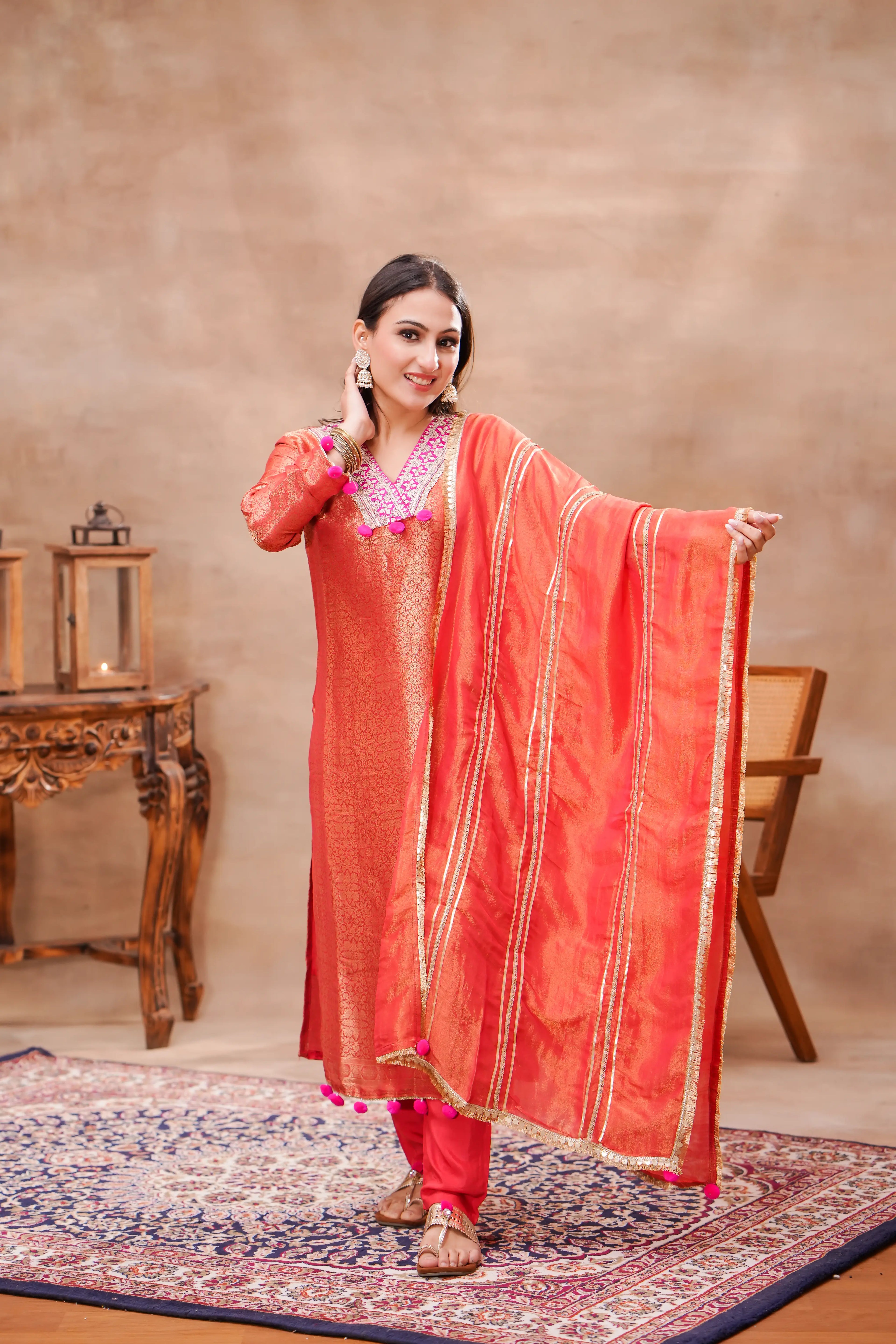 Shuchi Man Vermilion brocade silk kurta set with matching silk dupatta, featuring intricate traditional embroidery and festive design.