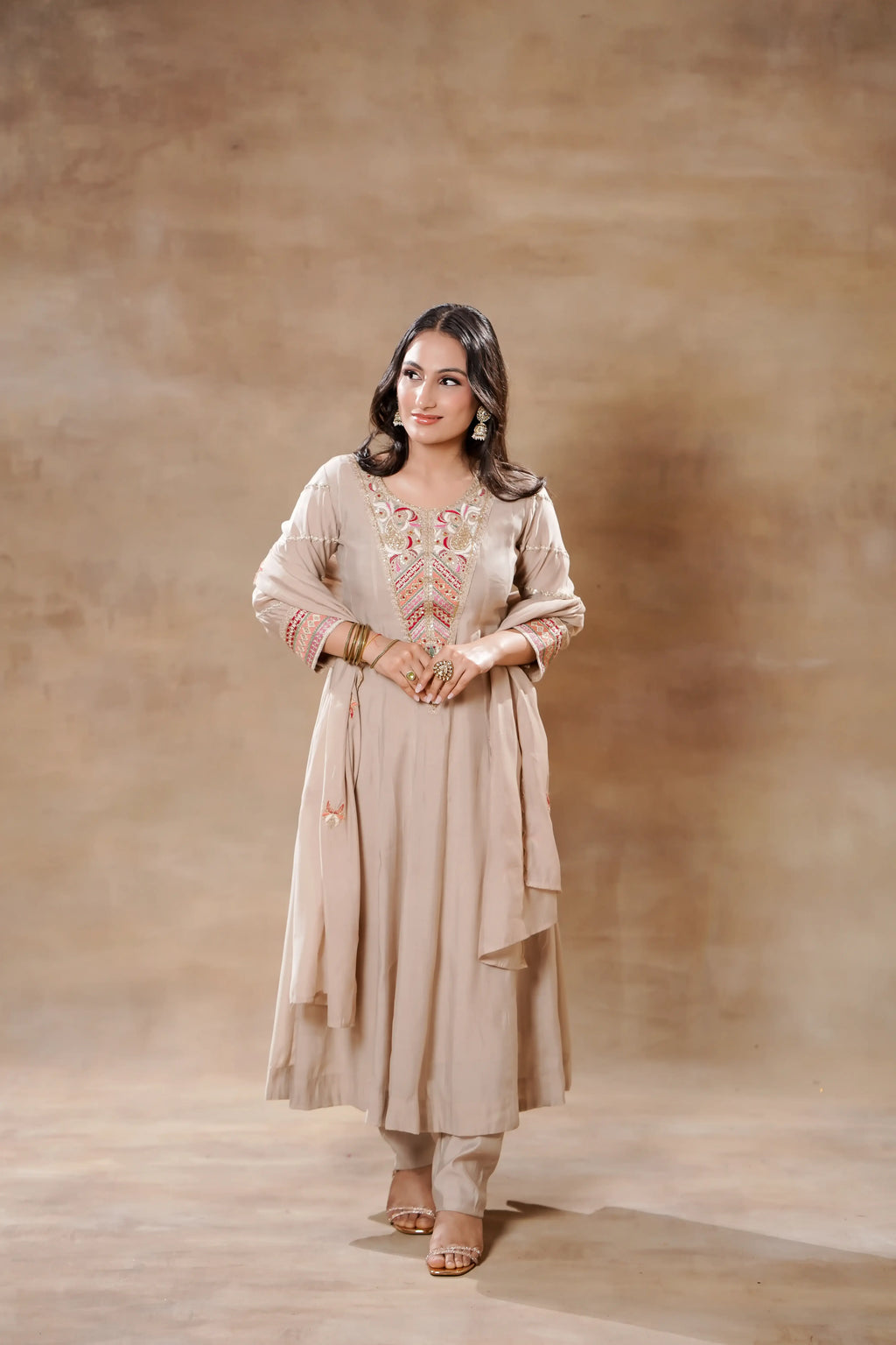 Beige Bloom Silk Anarkali set by Shuchi Man featuring intricate embroidery, flowing fabric, and traditional festive style.