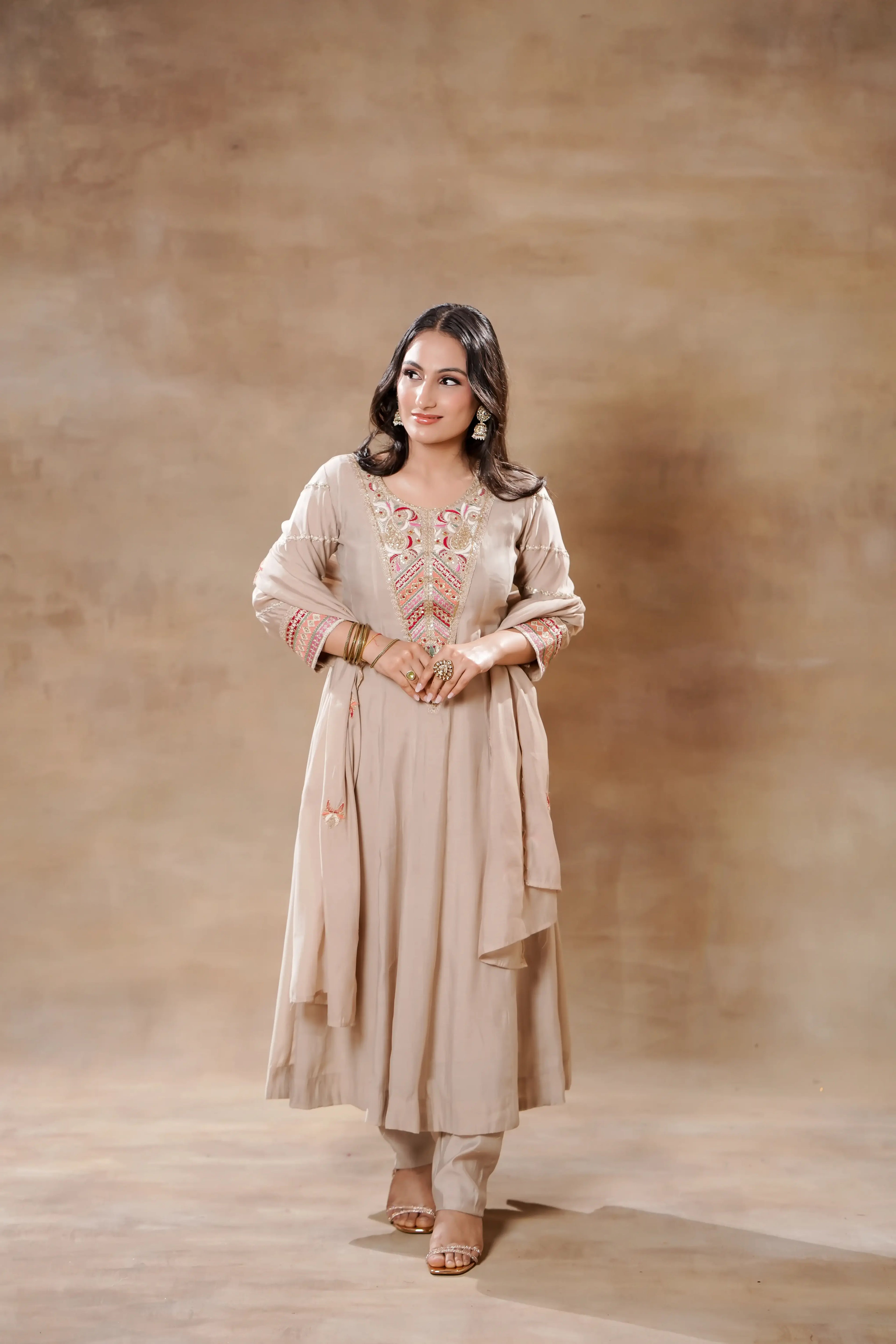Beige Bloom Silk Anarkali set by Shuchi Man featuring intricate embroidery, flowing fabric, and traditional festive style.