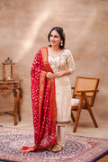 Ivory silk kurta set with intricate bandhani dupatta by Shuchi Man, featuring elegant traditional embroidery for festive occasions.