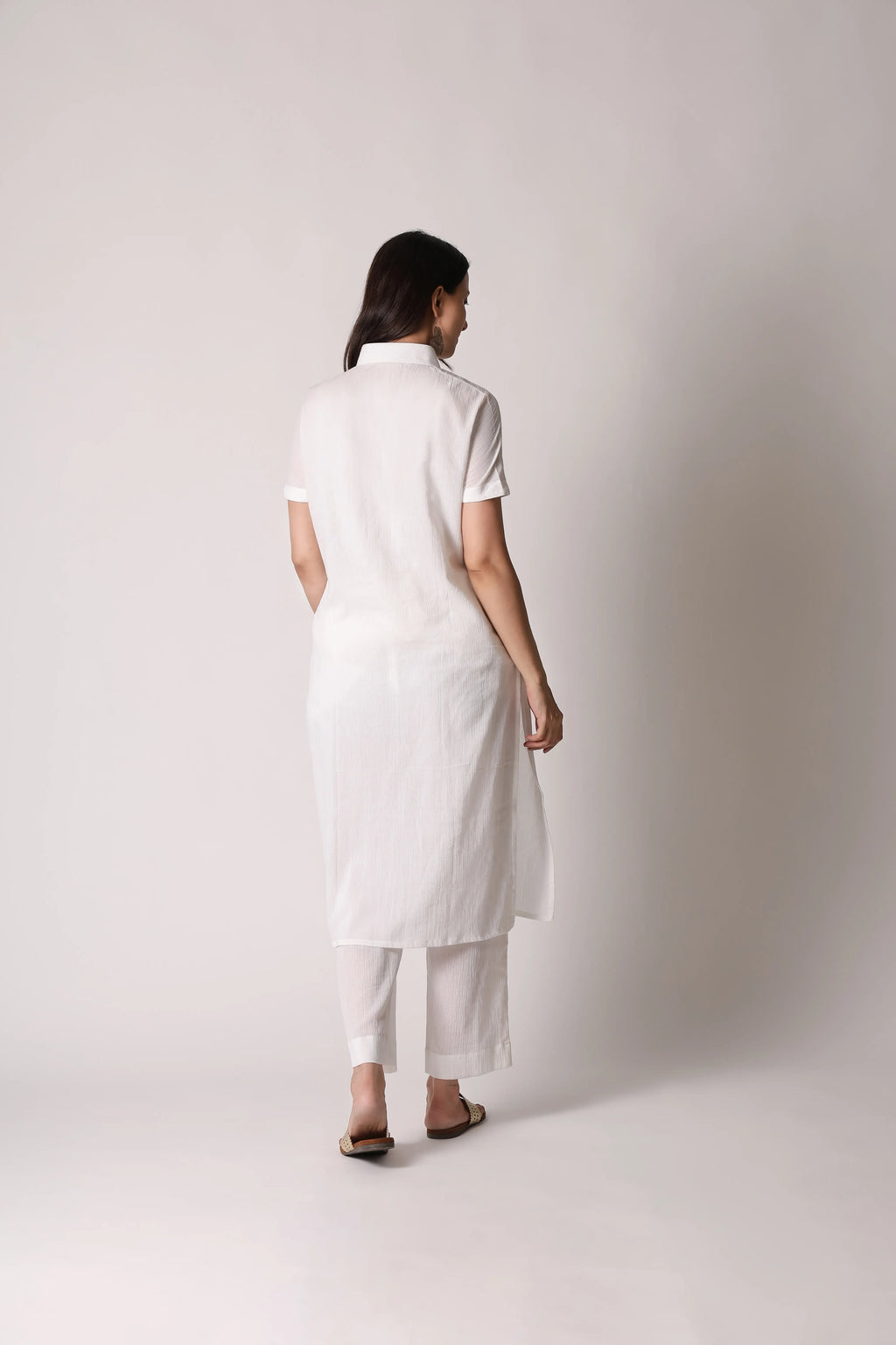 White canvas crinkle co-ord set by Shuchi Man featuring a relaxed fit top and matching wide-leg pants on a flat lay.
