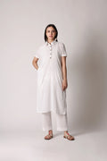 White canvas crinkle co-ord set by Shuchi Man featuring a relaxed fit top and matching wide-leg pants on a mannequin.