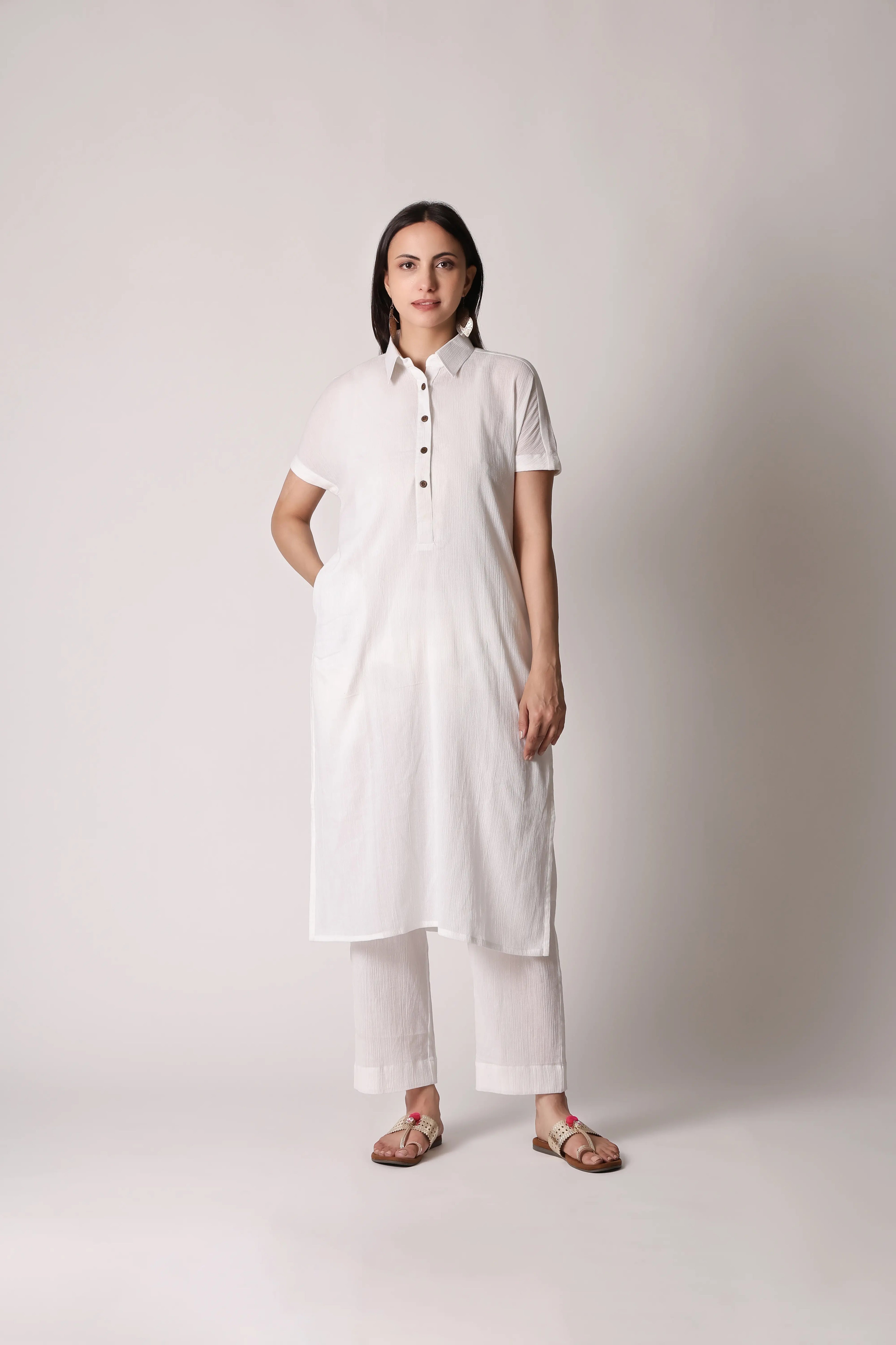 White canvas crinkle co-ord set by Shuchi Man featuring a relaxed fit top and matching wide-leg pants on a mannequin.
