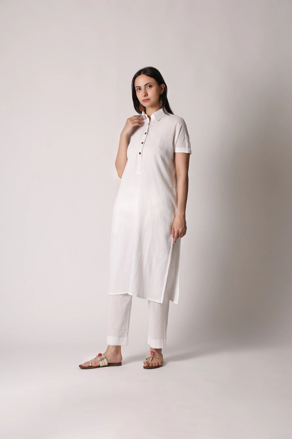 White canvas crinkle co-ord set by Shuchi Man featuring a matching top and pants with a relaxed, textured fabric.