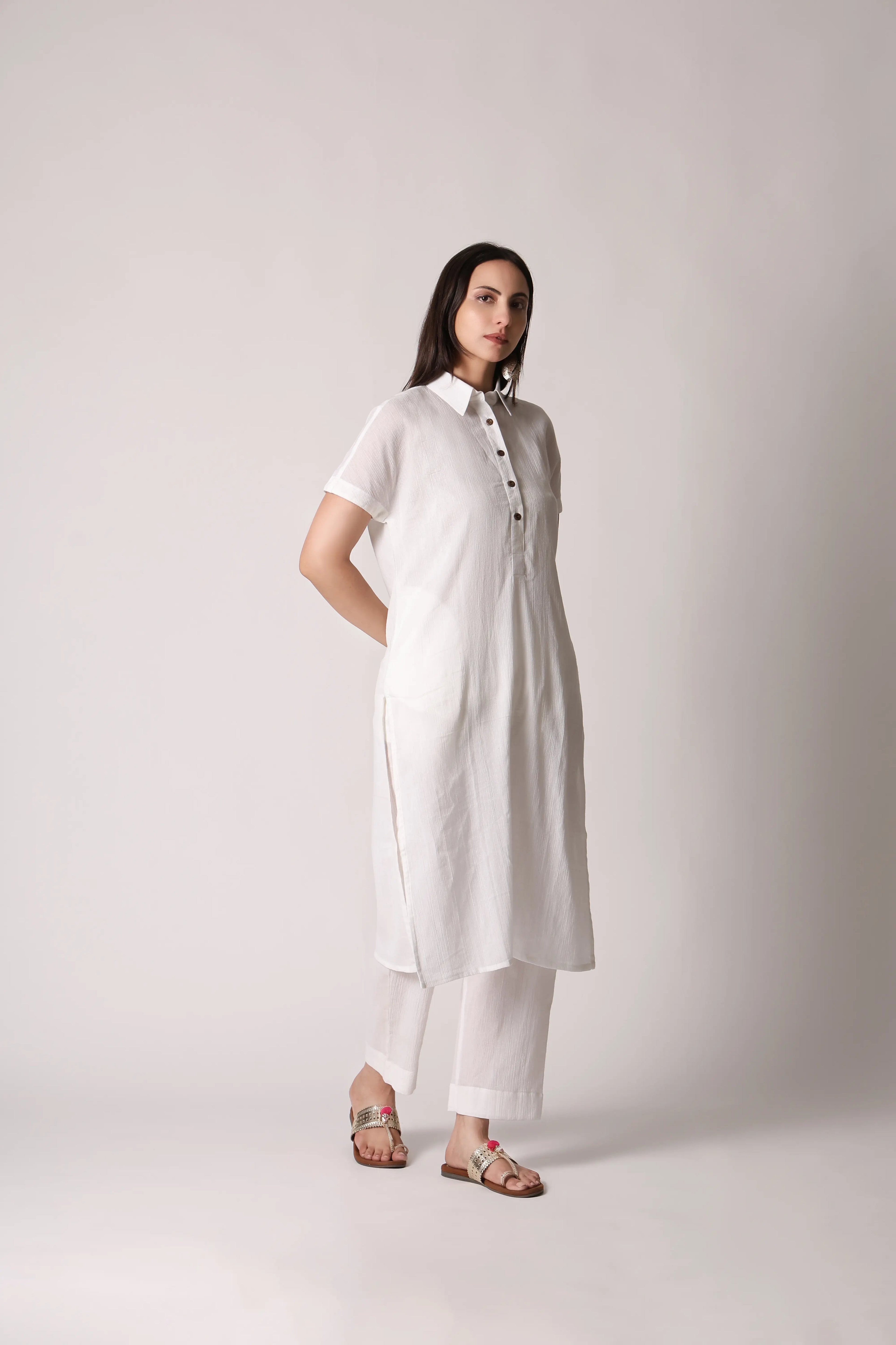 White canvas crinkle co-ord set by Shuchi Man featuring a matching top and pants with a relaxed fit and textured fabric.