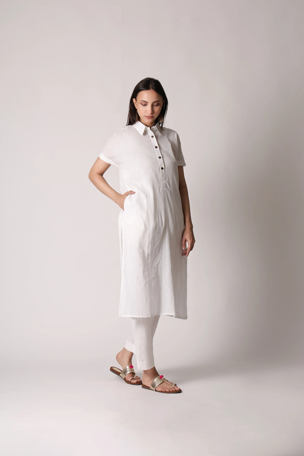 White canvas crinkle co-ord set by Shuchi Man featuring a cropped top and matching high-waisted pants, styled for casual wear.