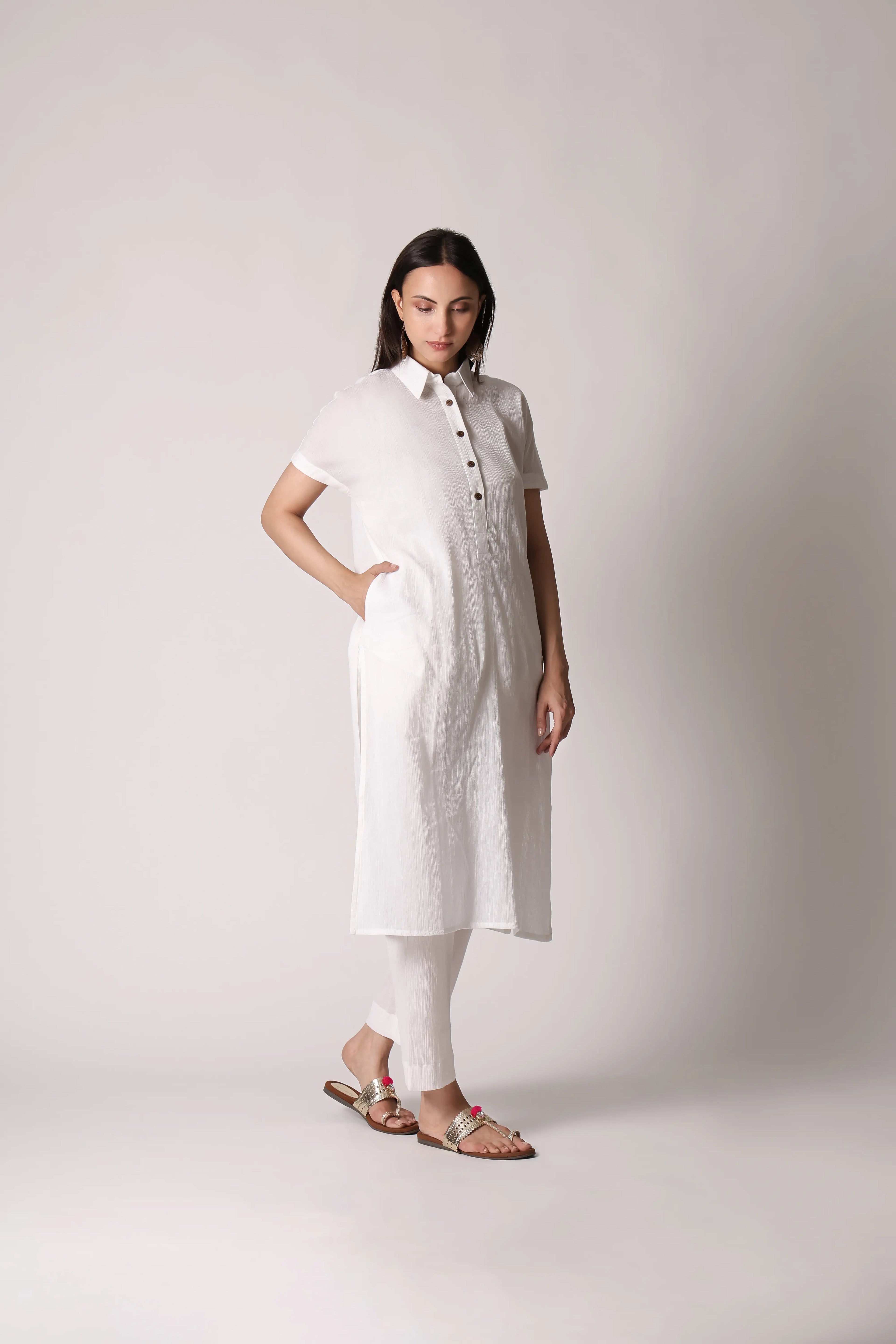 White canvas crinkle co-ord set by Shuchi Man featuring a cropped top and matching high-waisted pants, styled for casual wear.