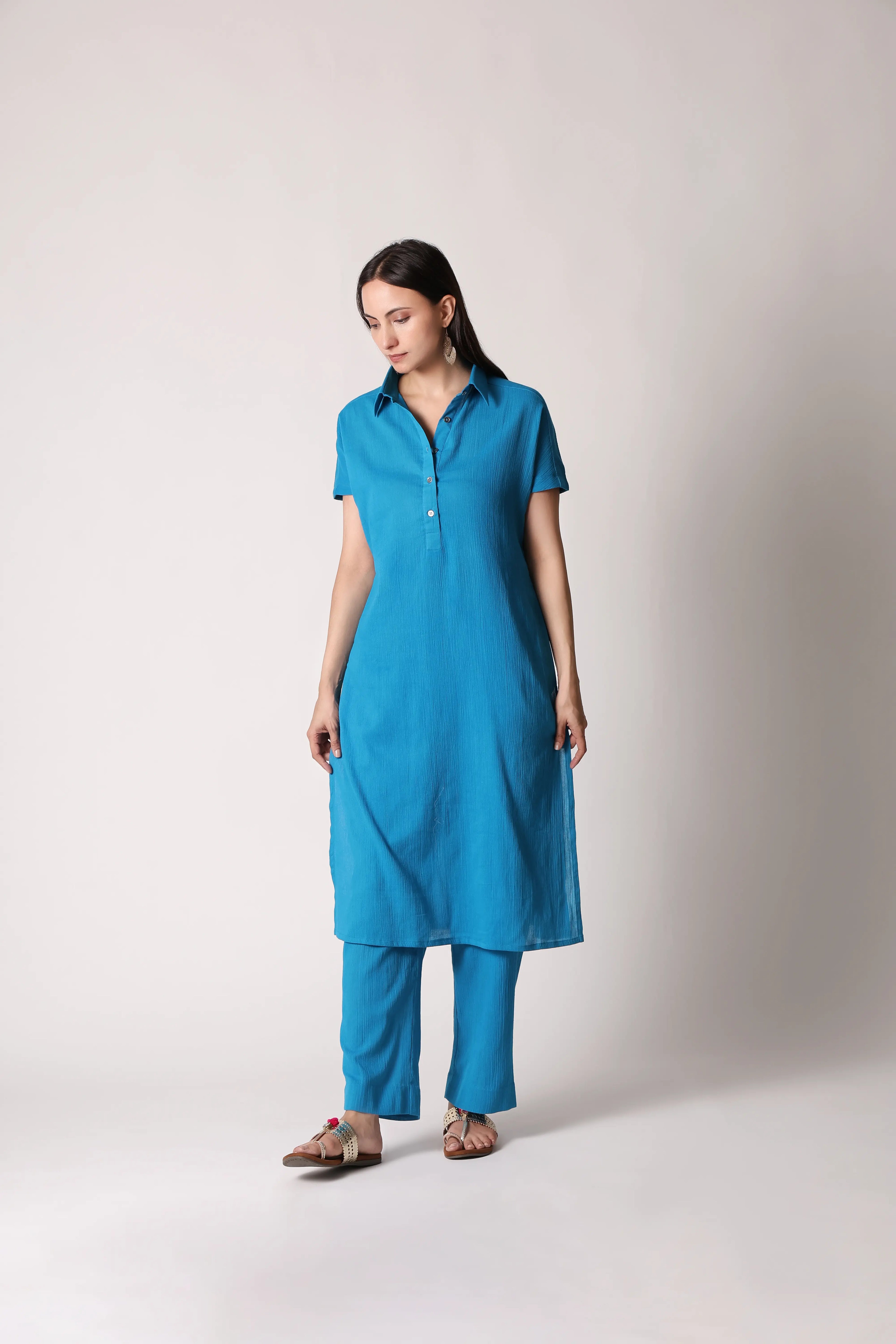 Turquoise Drift Crinkle Co-ord Set by Shuchi Man featuring a stylish matching top and pants with a textured, crinkled fabric.