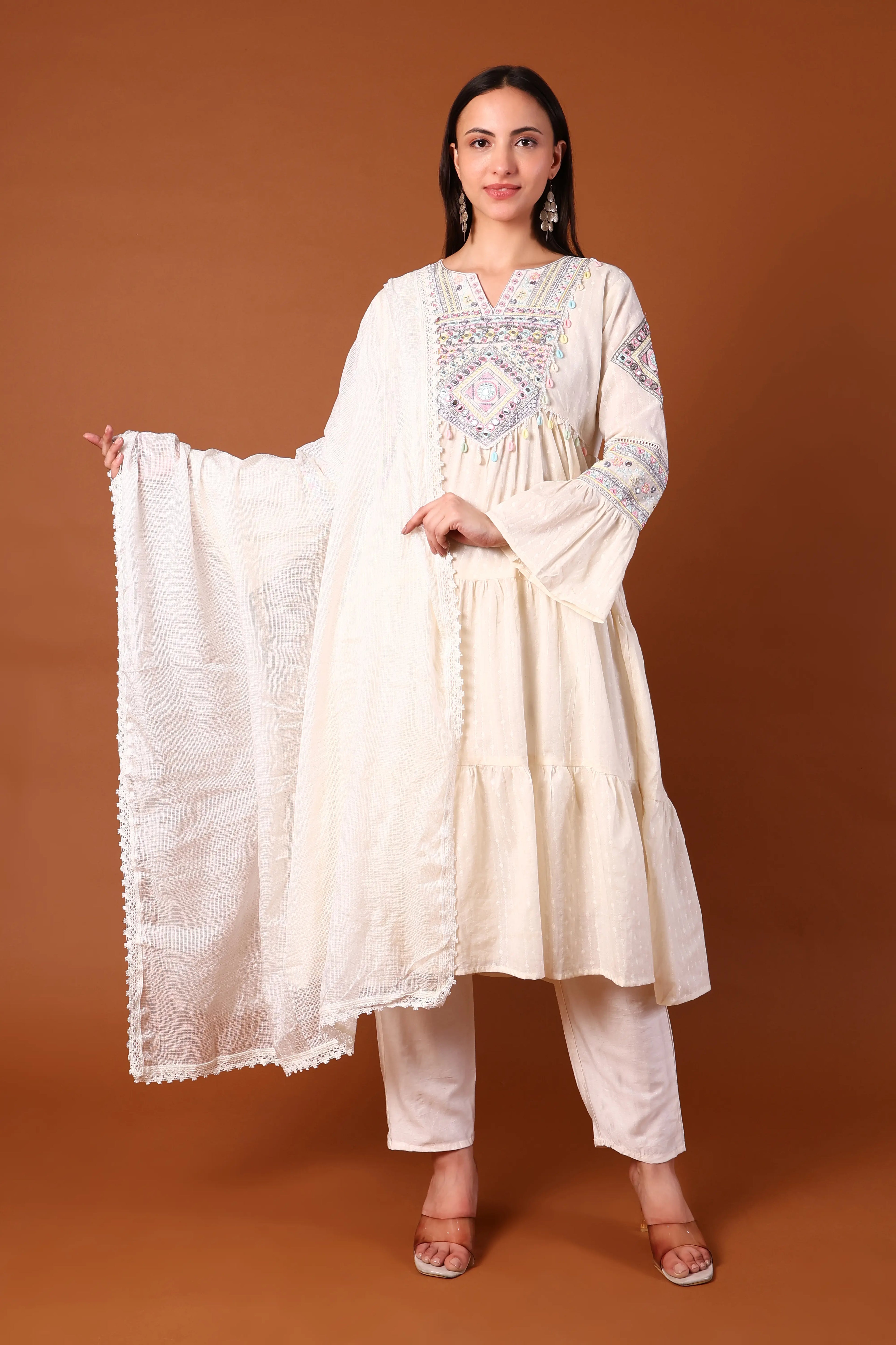 Ivory cotton kurta set with Kauri embellishments from Shuchi Man, featuring intricate embroidery and traditional design.
