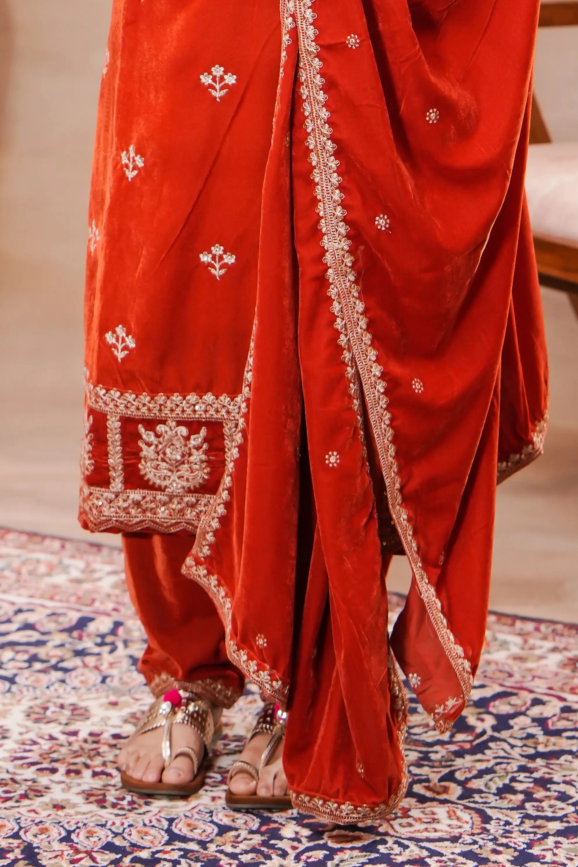 Rust-orange velvet embroidered suit set with kurta, matching bottom, and intricate embroidery by Shuchi Man.