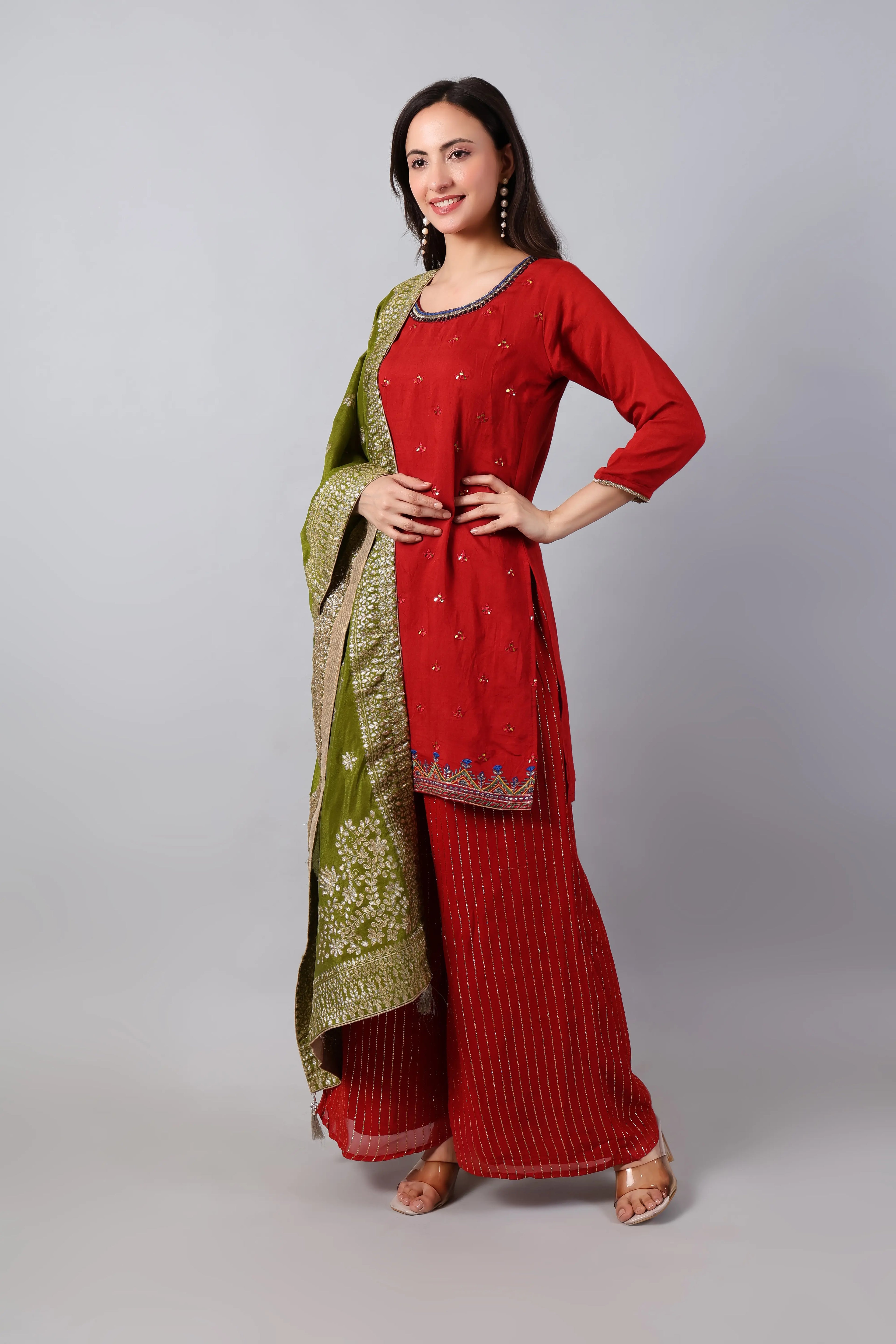 Red silk embroidered kurta with striped palazzo and mehndi green zari dupatta, styled by Shuchi Man.