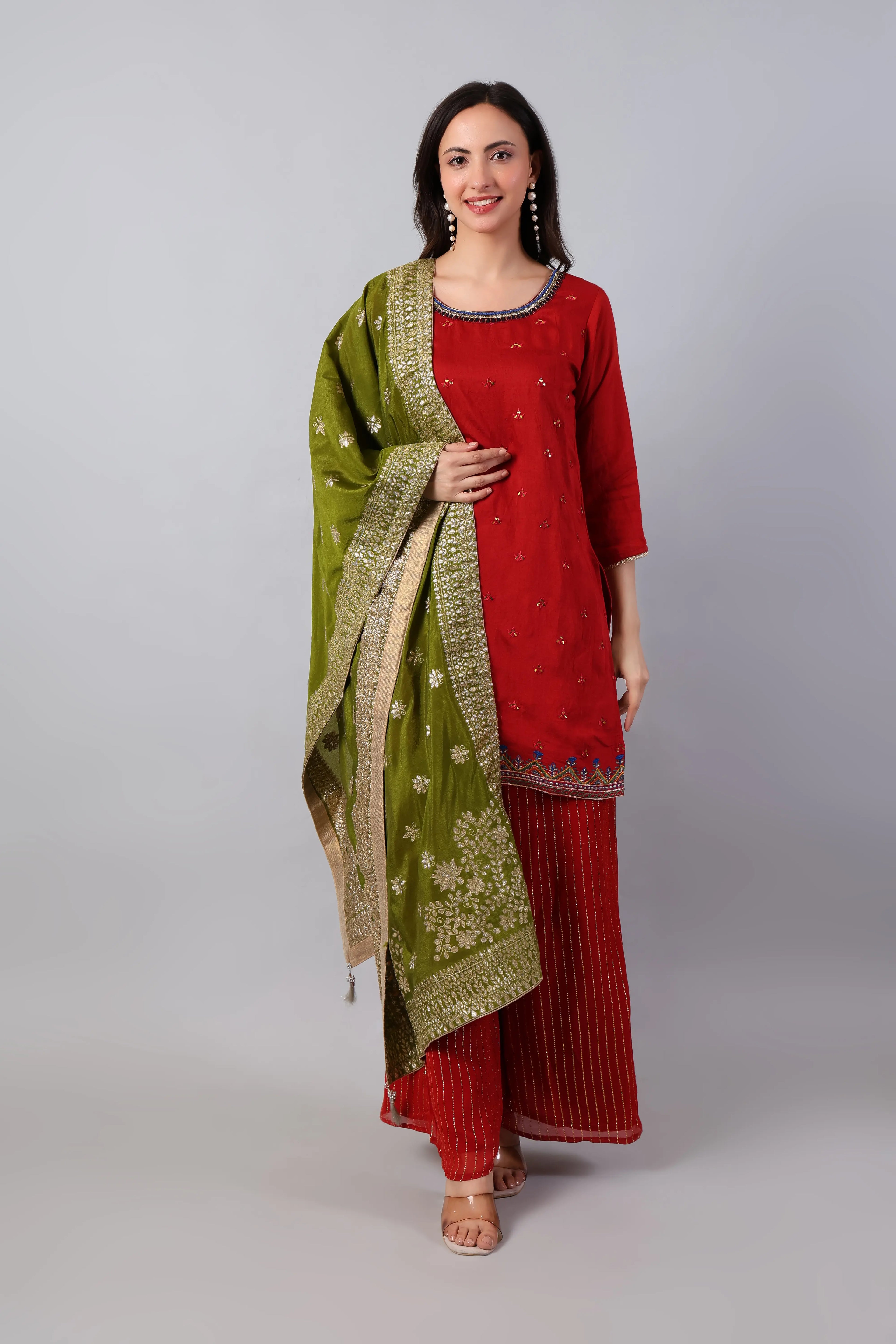Red silk embroidered kurta with striped palazzo and mehndi green zari dupatta, Shuchi Man traditional Indian outfit front view.