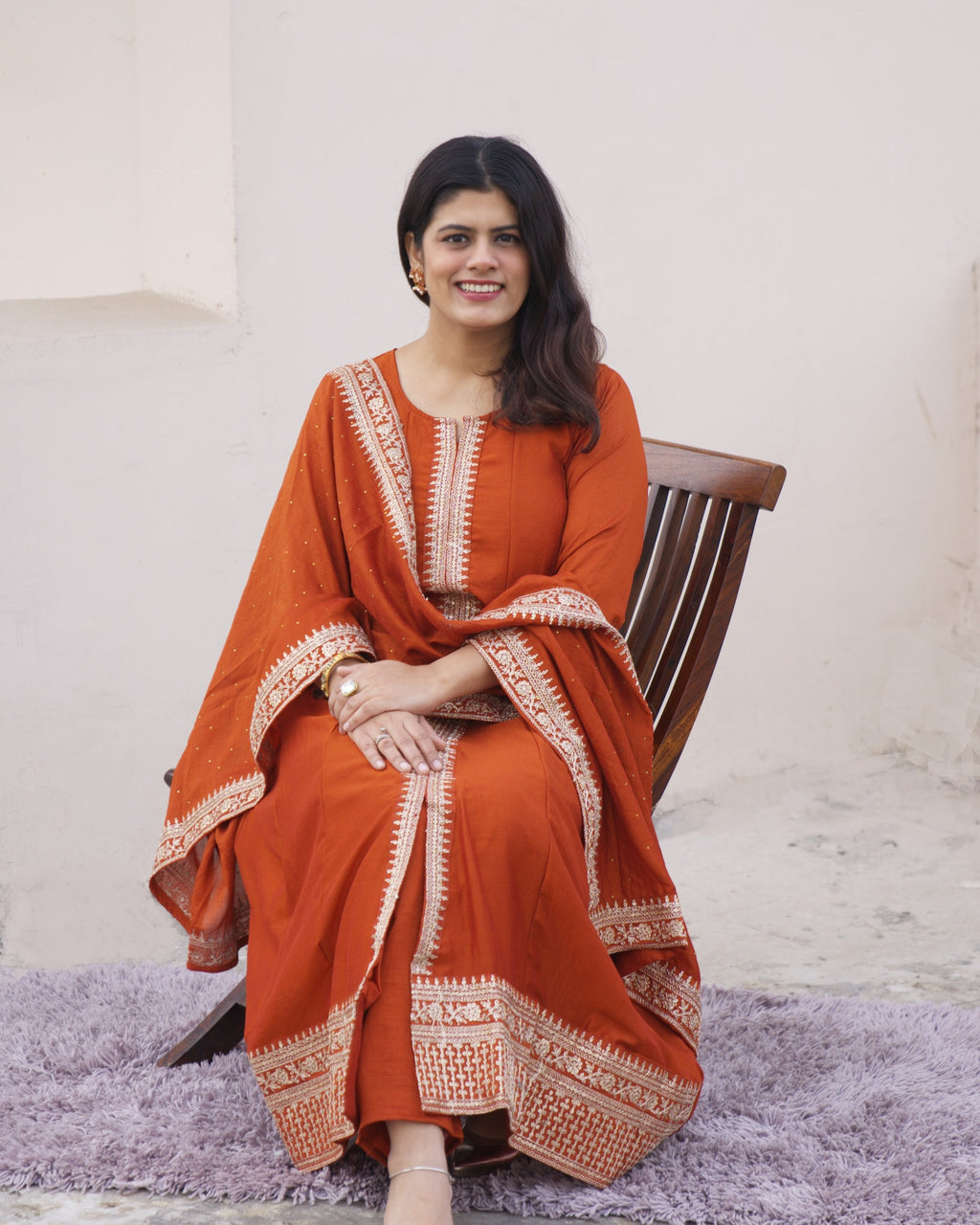 Rust-orange silk Anarkali set for women by Shuchi Man, featuring a flowing kurta, matching pants, and dupatta in elegant design.