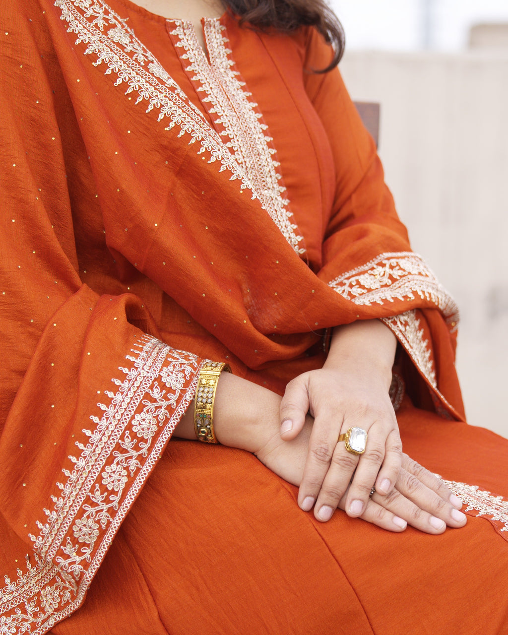 Close-up of Shuchi Man Rust Radiance Silk Anarkali Set featuring rust-orange kurta, matching pants, and dupatta.